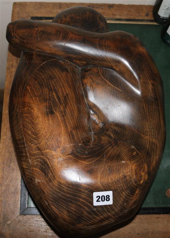 A carved wood model of crouching woman